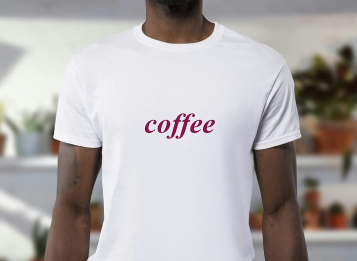 A man wearing a white shirt with the word "coffee"